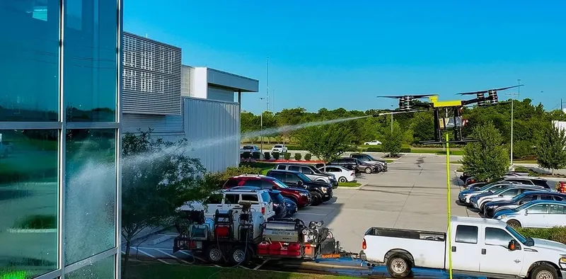 Using Apellix Drone to clean the Exterior Surface of the building with FlyWash Drone operator