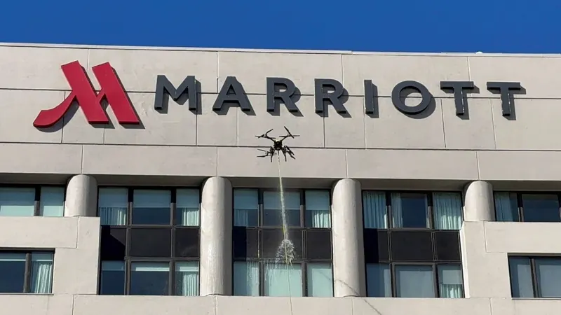 FlyWash drone washing a Marriott hotel facade